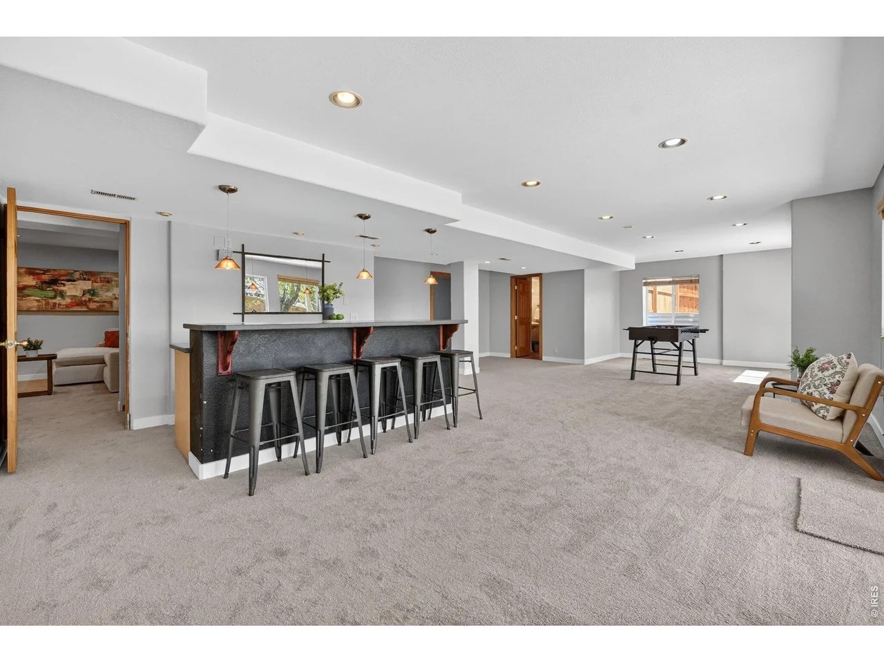 Walk out basement Bar featuring a fooseball table styled and curated by STS Boulder Foothills